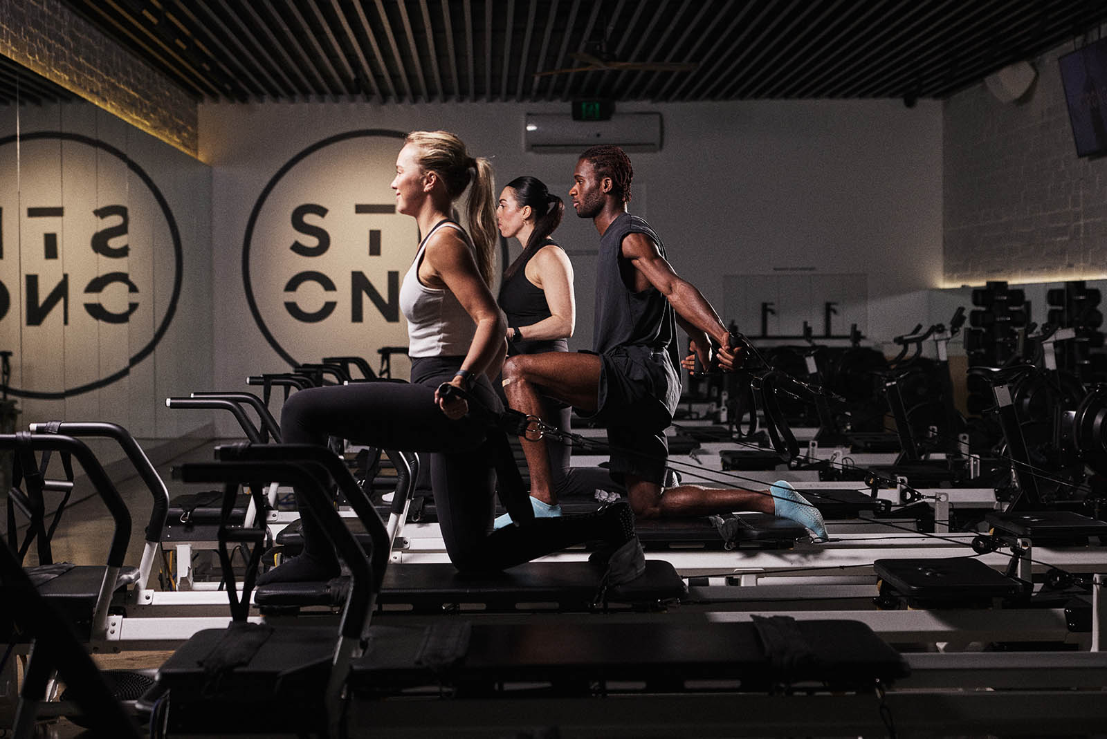 Members lunging on Rowformers in a STRONG class